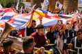 A big group of people in a parade with country flags.
